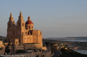 mellieha church bathed in the golden glow of sunrise dario vella