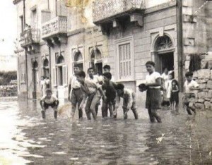 photo from the past! Children play around in flood waters after a heavy autumn downpour lawrence ciantar